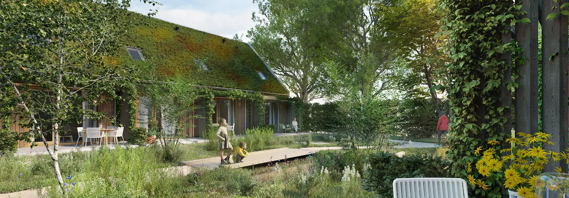 Een groene woonomgeving in GeWOON Groen Didam, met in hout gebouwde huizen voorzien van sedumdaken, een natuurlijk ingerichte tuin en ruimte voor kinderen.